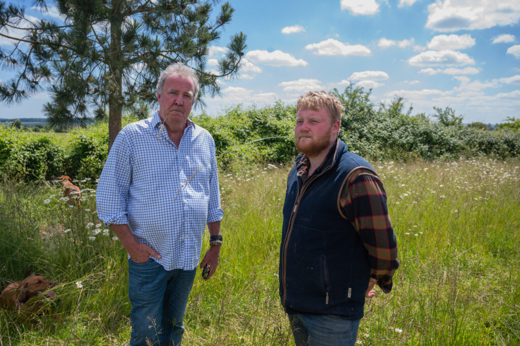 Jeremy Clarkson and Kaleb Cooper standing in a field